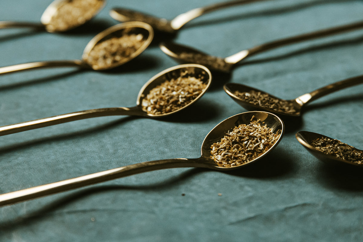 Tea ingredients displayed in spoons